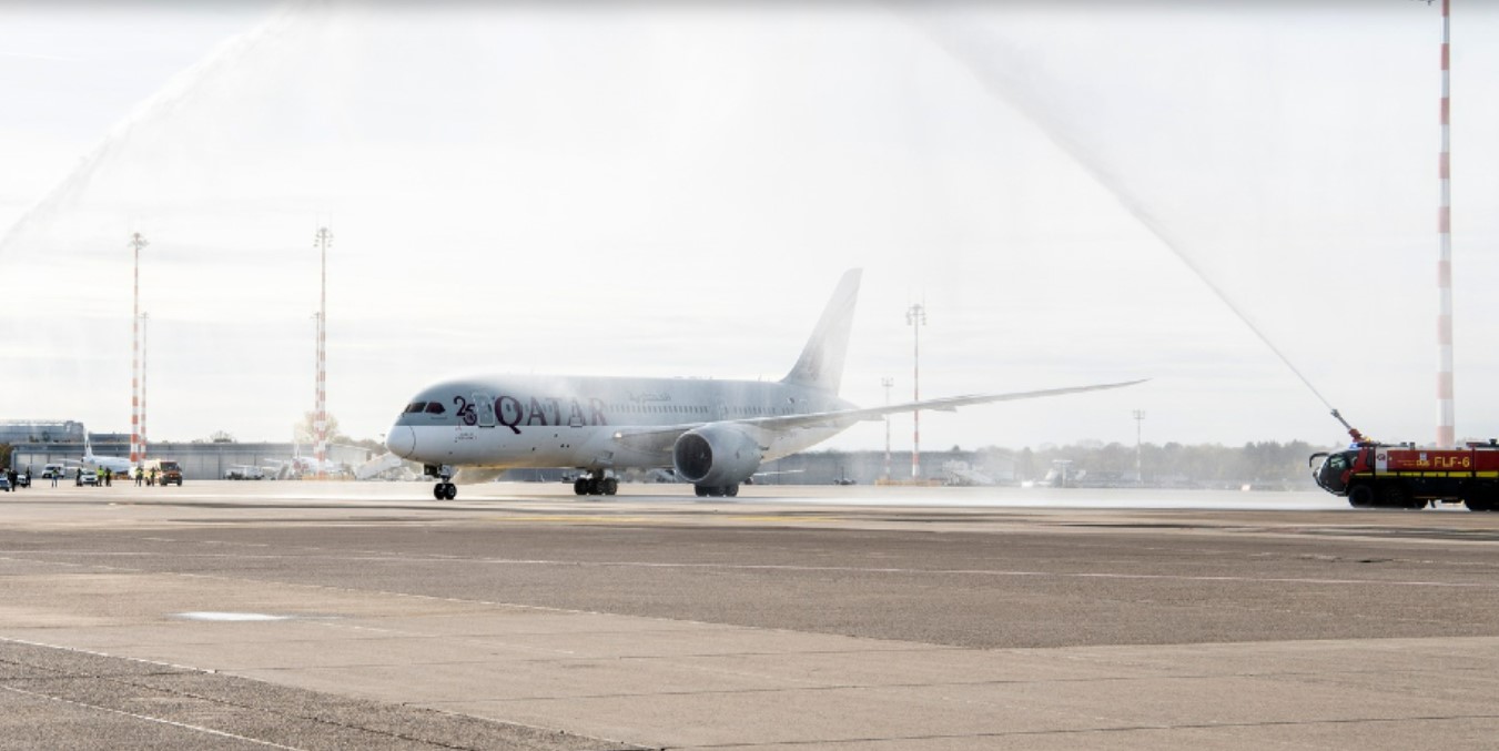 A Qatar Airways Dreamliner receives a water cannon salute at Dusseldorf Airport
