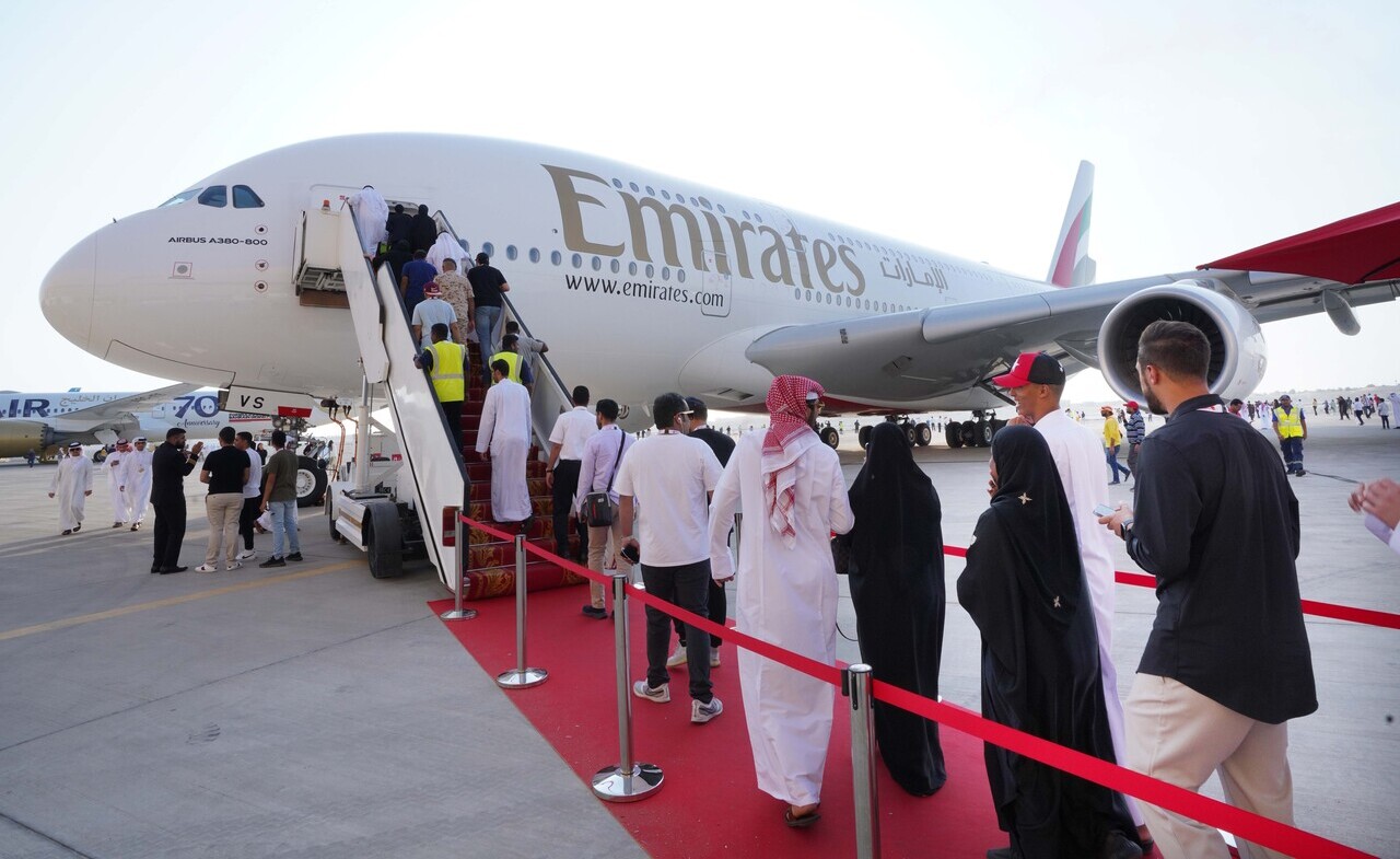 Bahrain Airshow patrons board an Emirates A380 parked on display.
