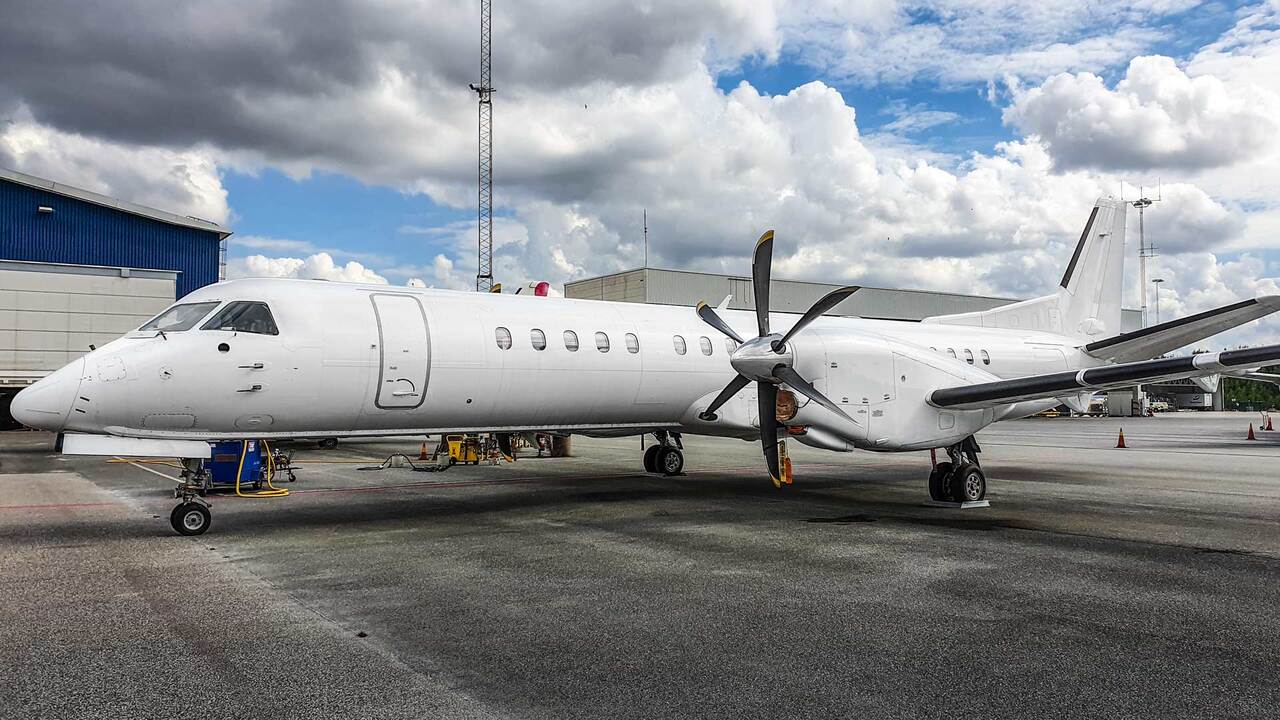 A SAAB 2000 parked on the tarmac.