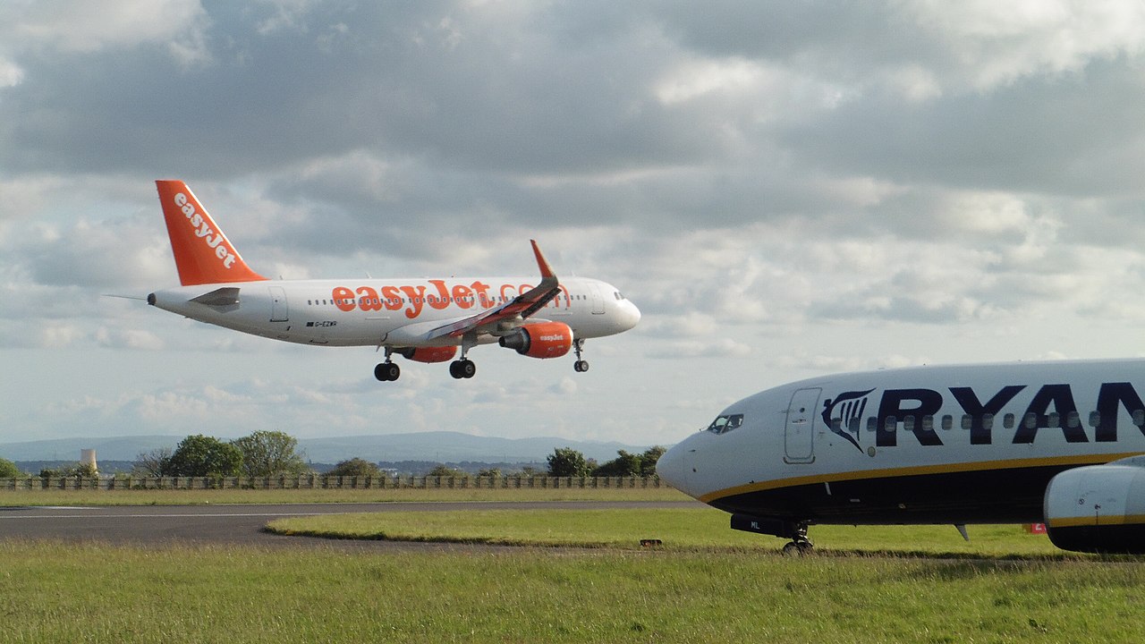 A Ryanair jet waits for an easyJet aircraft to land.