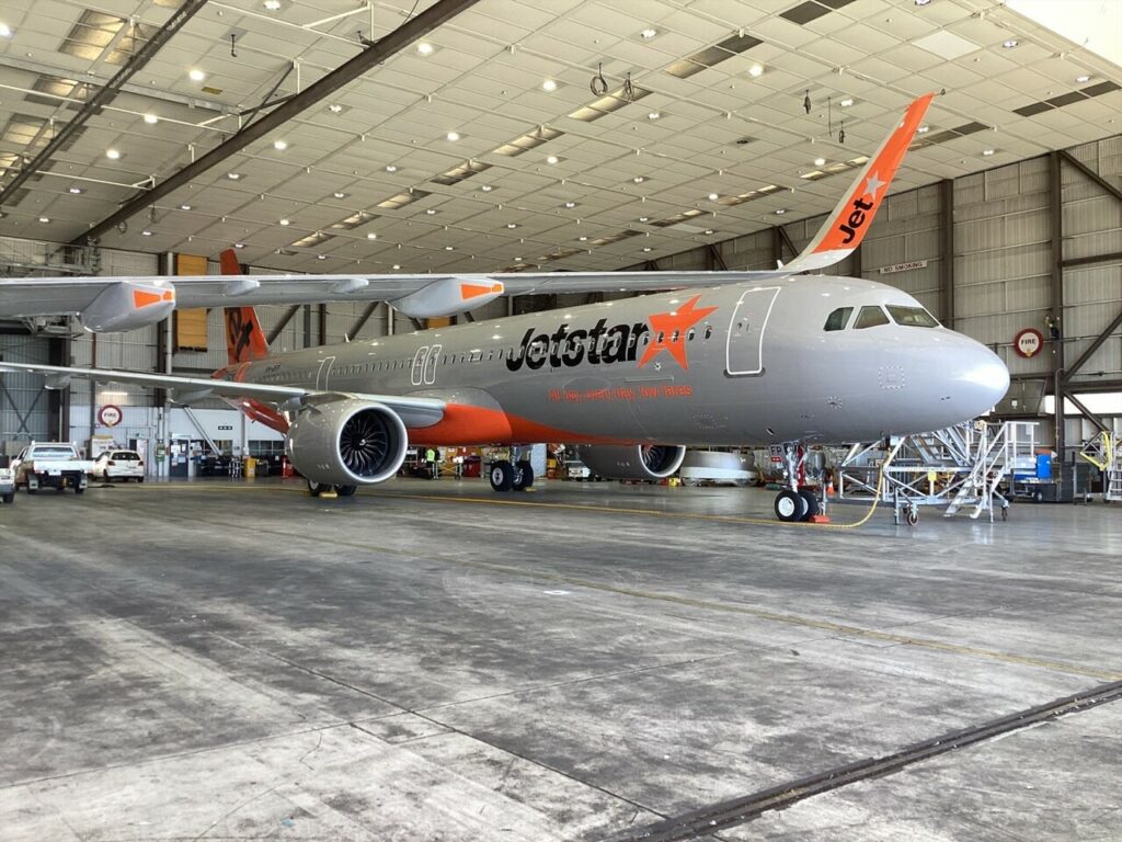 Two new Jetstar Airbus A321neo aircraft parked in the hangar.