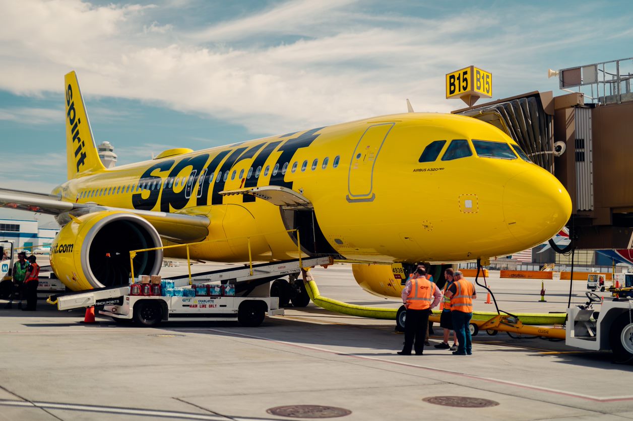 A Spirit Airlines A320 with ground staff.