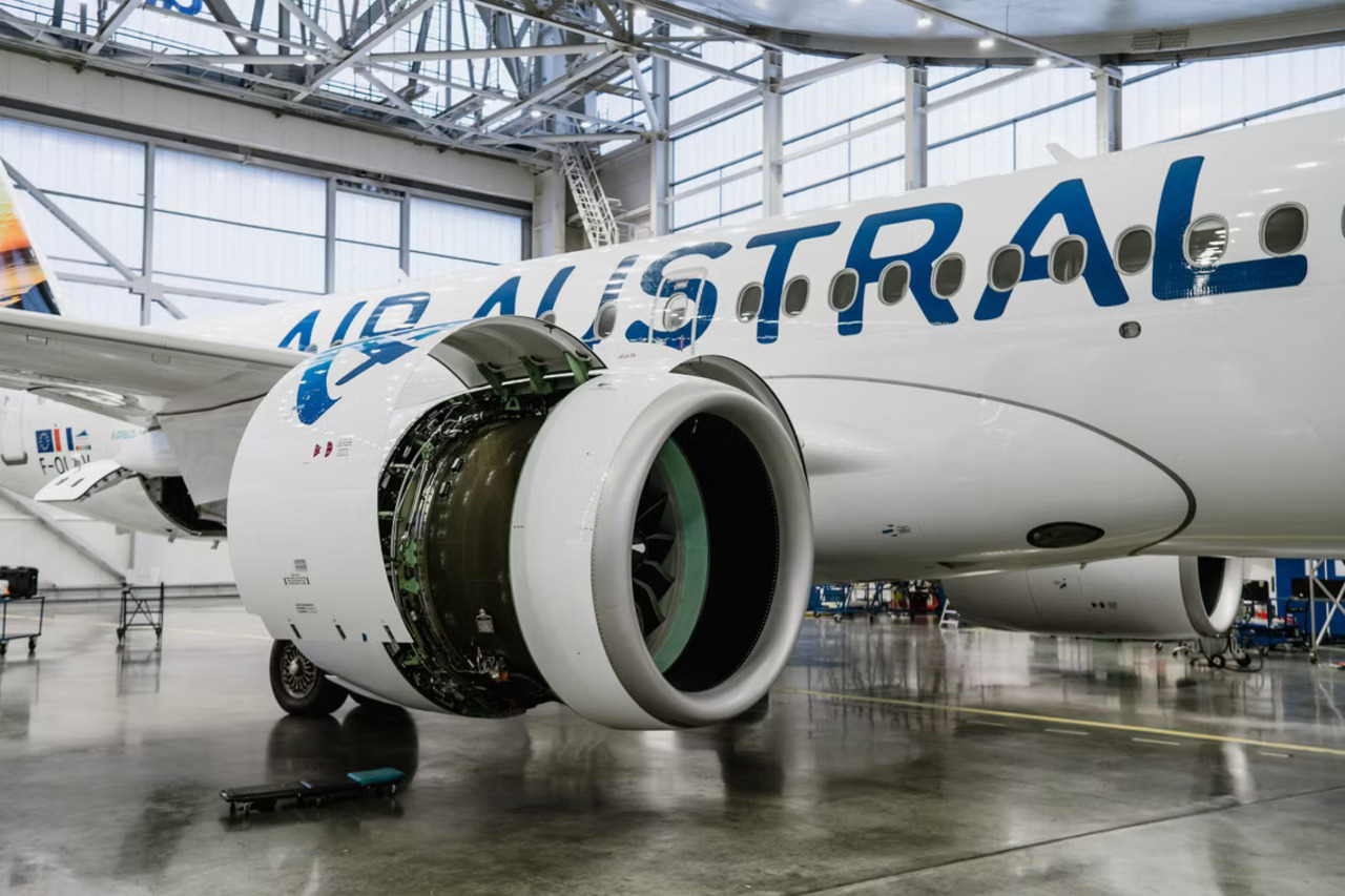 An Air Austral Airbus A220 in the airBaltic hangar for maintenance.