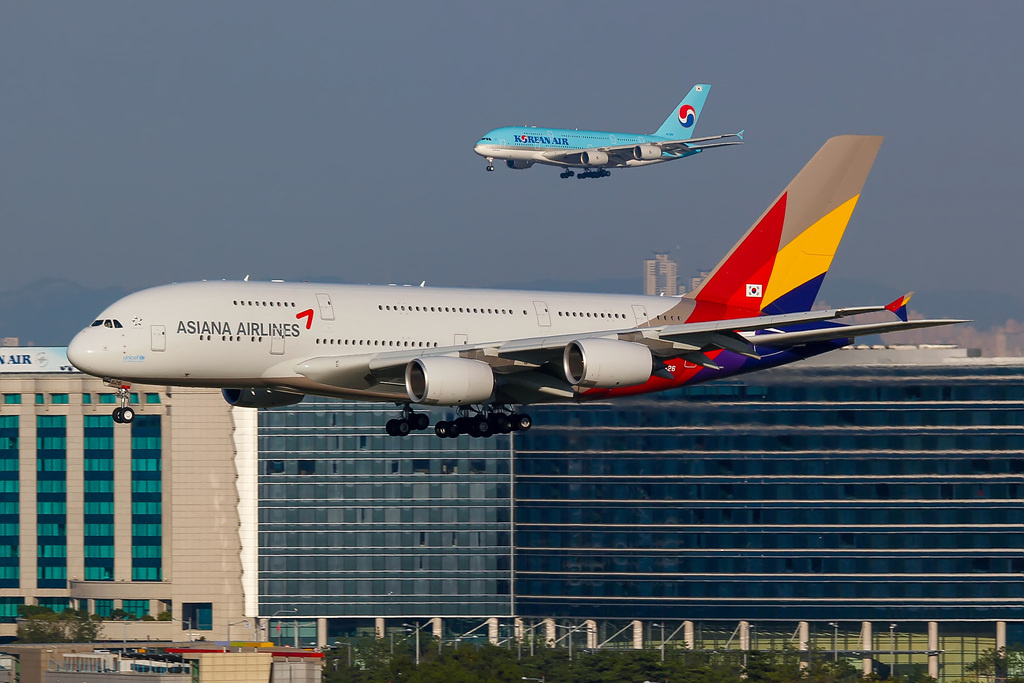 A Korean Air and an Asiana Airlines aircraft both approaching to land.