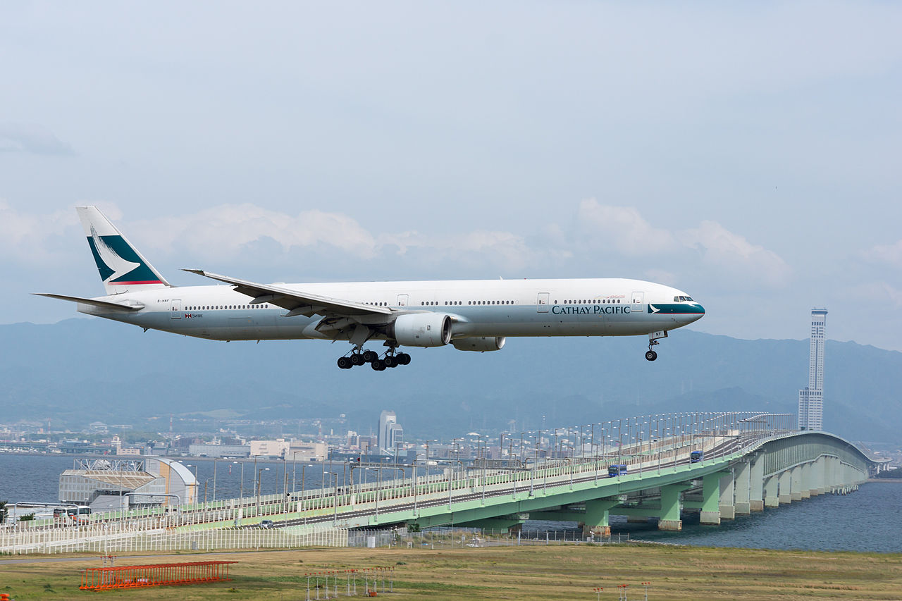 A Cathay Pacific flight approaches to land at Kansai Airport in Osaka, Japan.