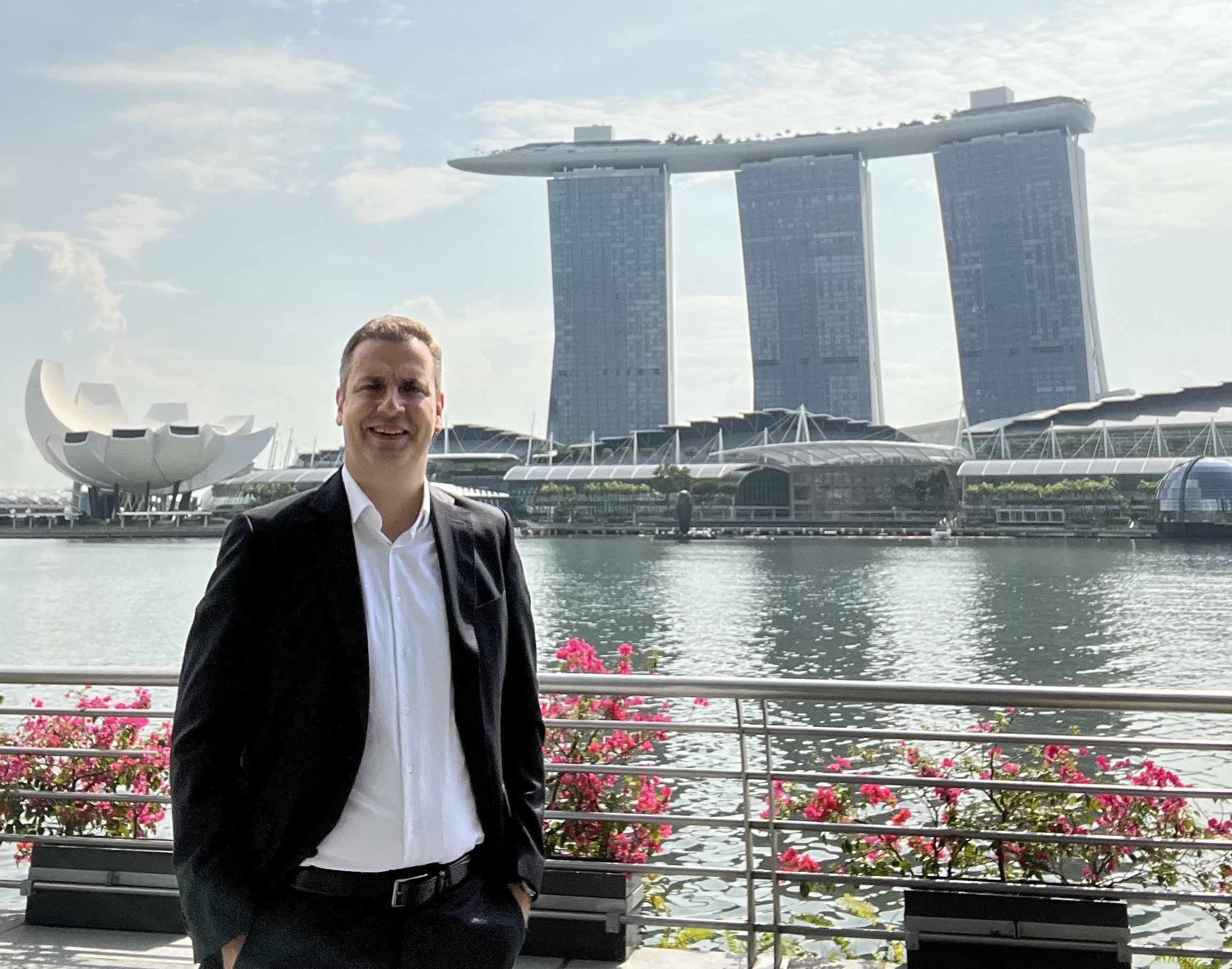 Simon Cotter, head of Munich Airport Group Singapore office stands in front of Singapore's Marina Bay.