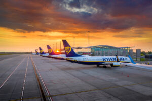 A line-up of Ryanair aircraft at sunset.