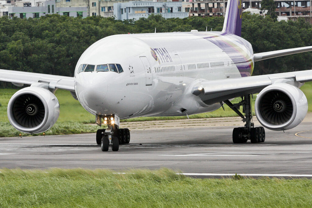 A Thai Airways Boeing 777 turns onto the runway.