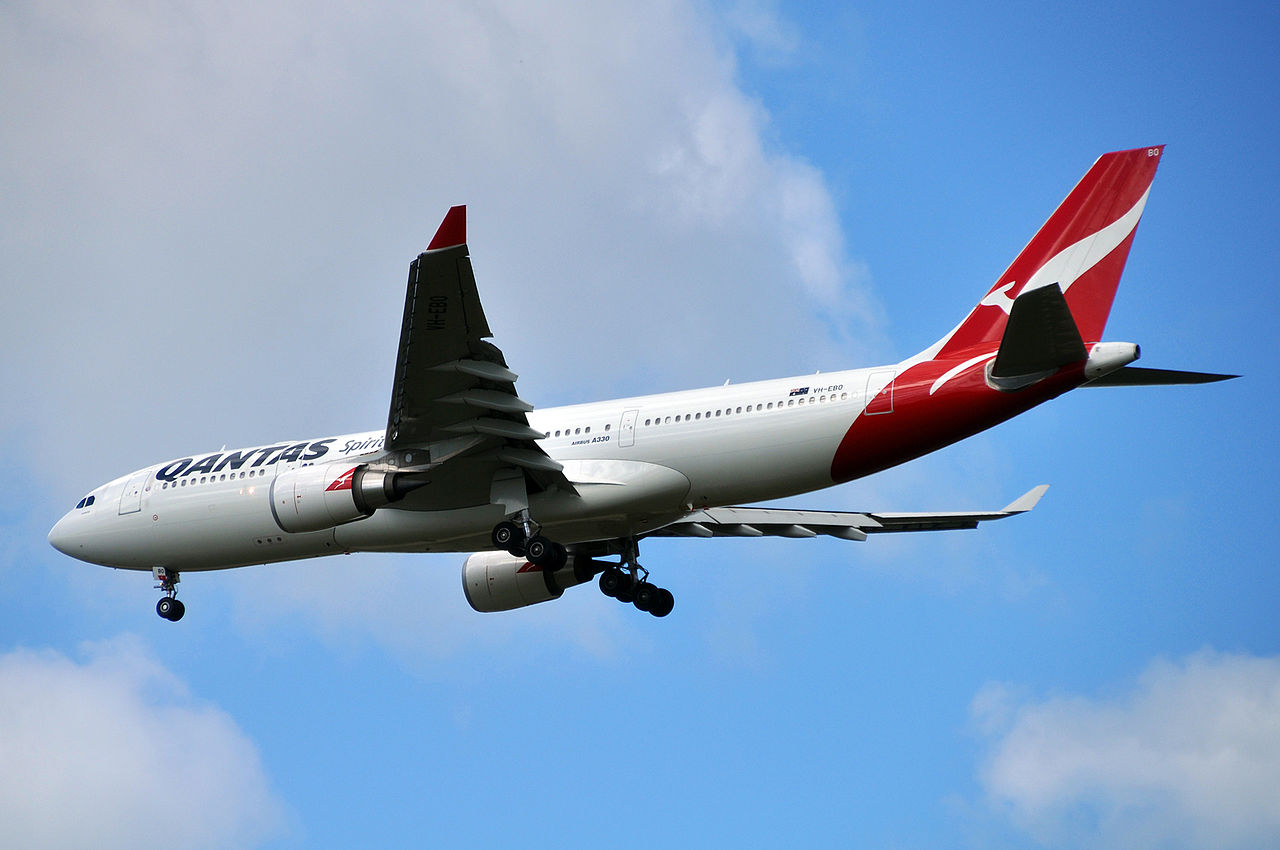 A Qantas A330 passes overhead.