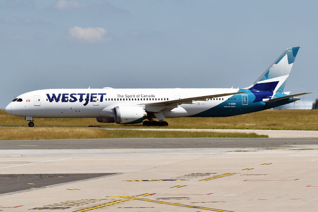 A WestJet Boeing 787 Dreamliner lines up on the runway.