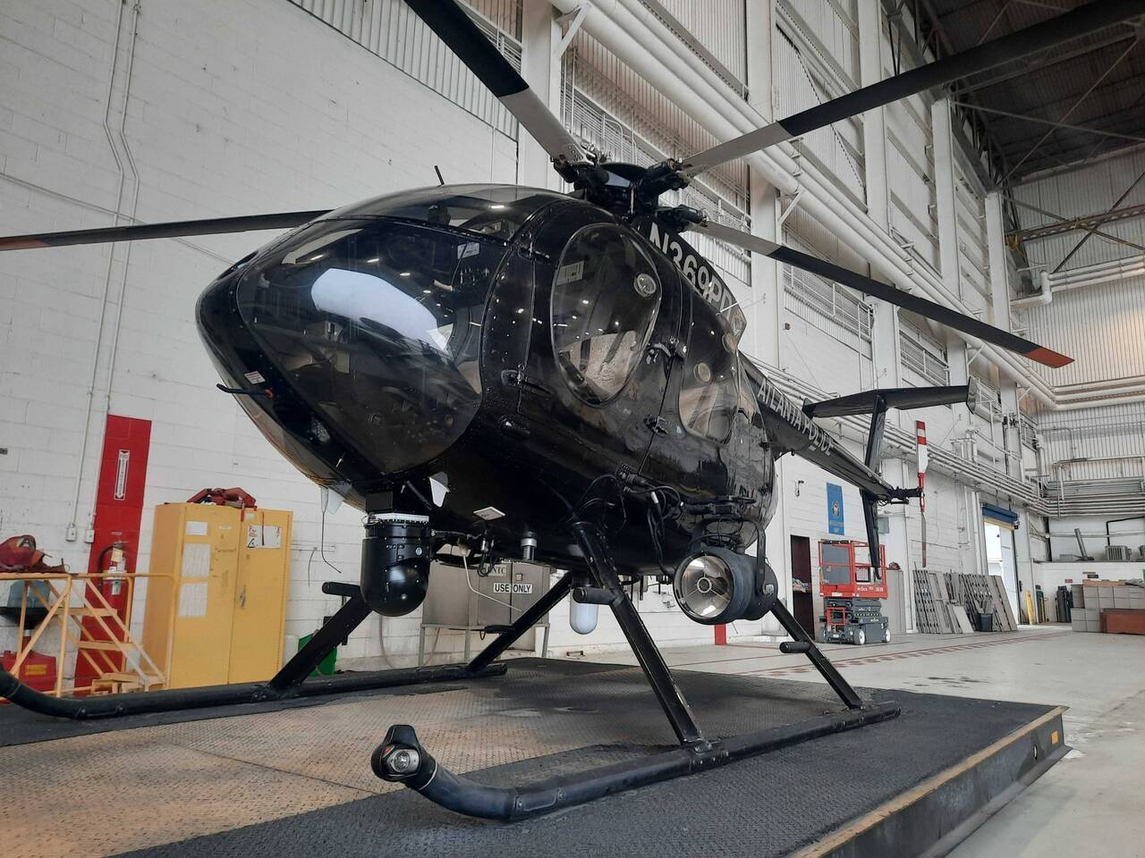 An Atlanta Police Department MD 580E helicopter in the hangar.
