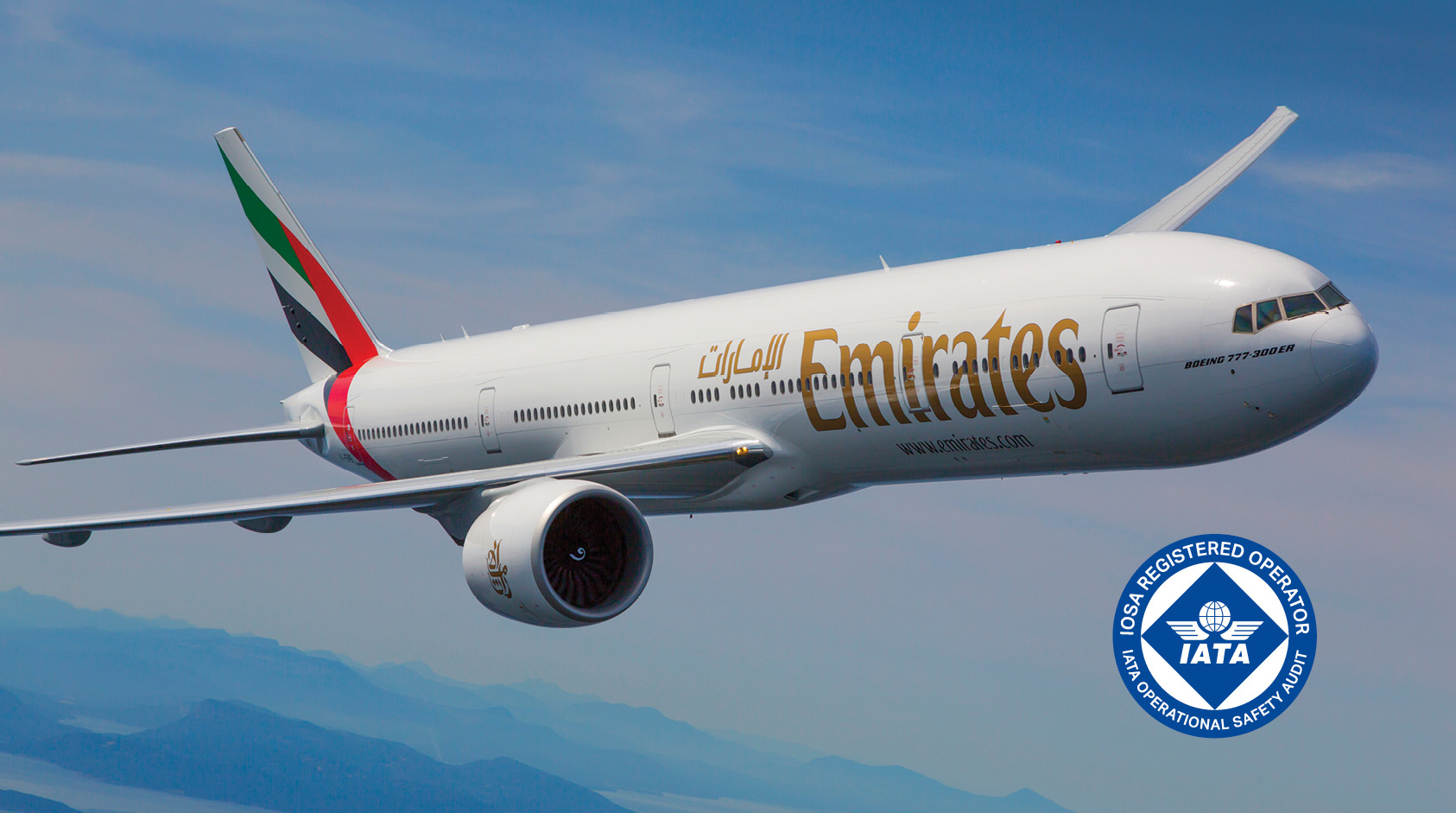 An Emirates Airbus in flight with IATA logo