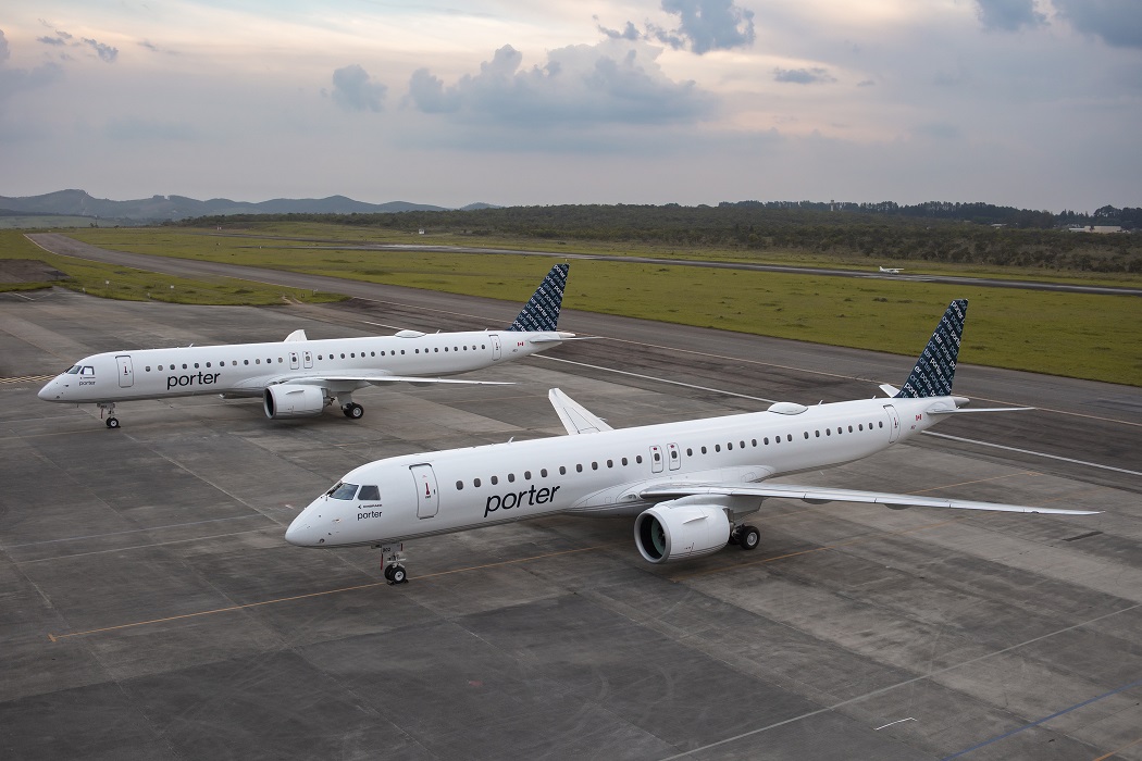 Two Embraer E195-E2 jets stand on the tarmac in Porter Airlines livery.