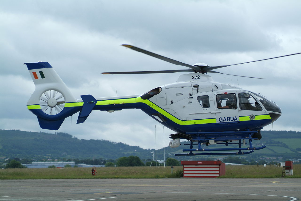 A Ireland garda Air Support Unit Eurocopter helicopter hovers on landing.