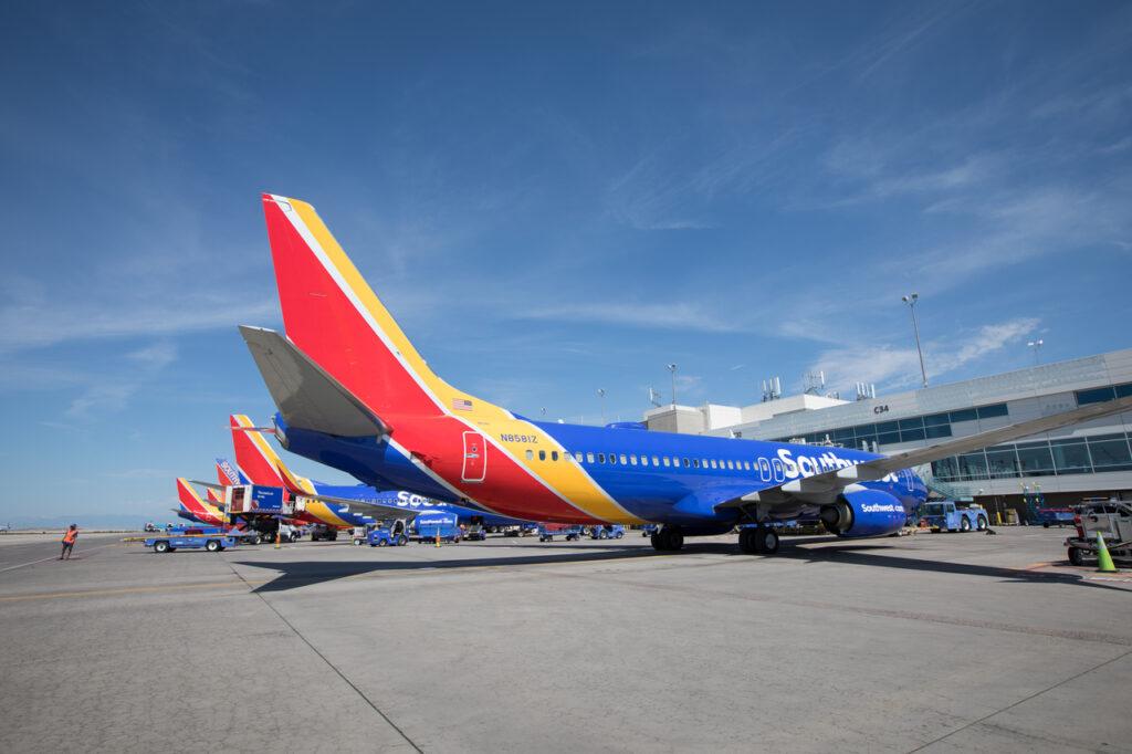 A line of Southwest Airlines aircraft parked at the terminal.