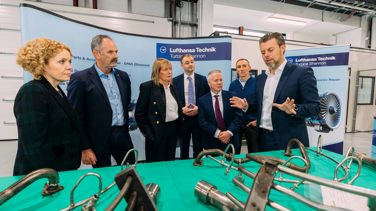 Lufthansa Technik Shannon officials with engine components.