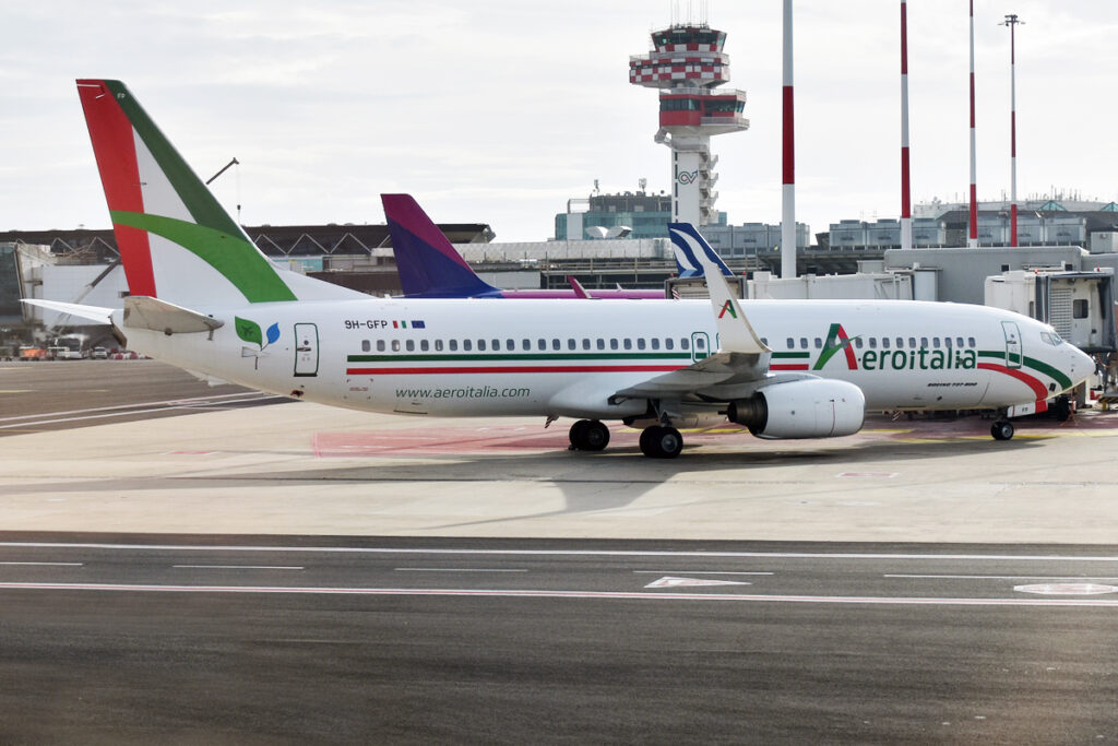 An Aeroitalia Boeing 737 parked at the ramp.