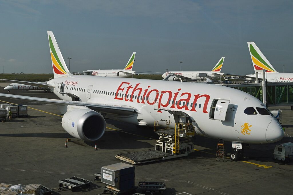 An Ethiopian Airlines Boeing 787-8 is loaded at the terminal.