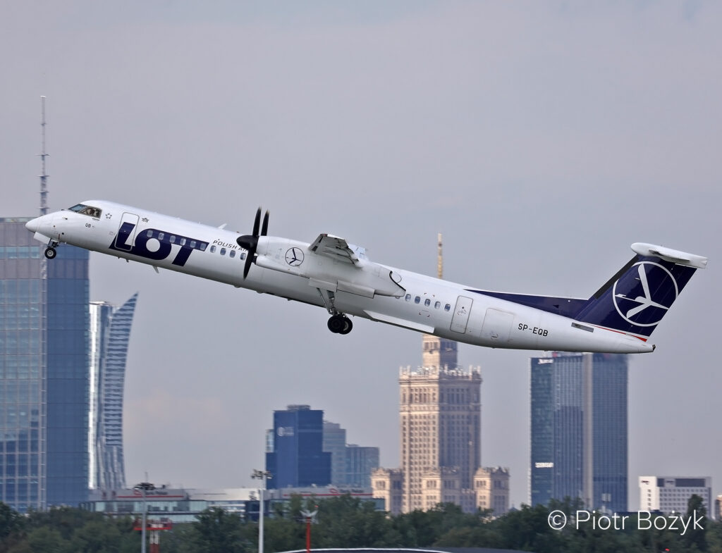 A LOT Polish Airlines Dash 8-400 climbs after takeoff.