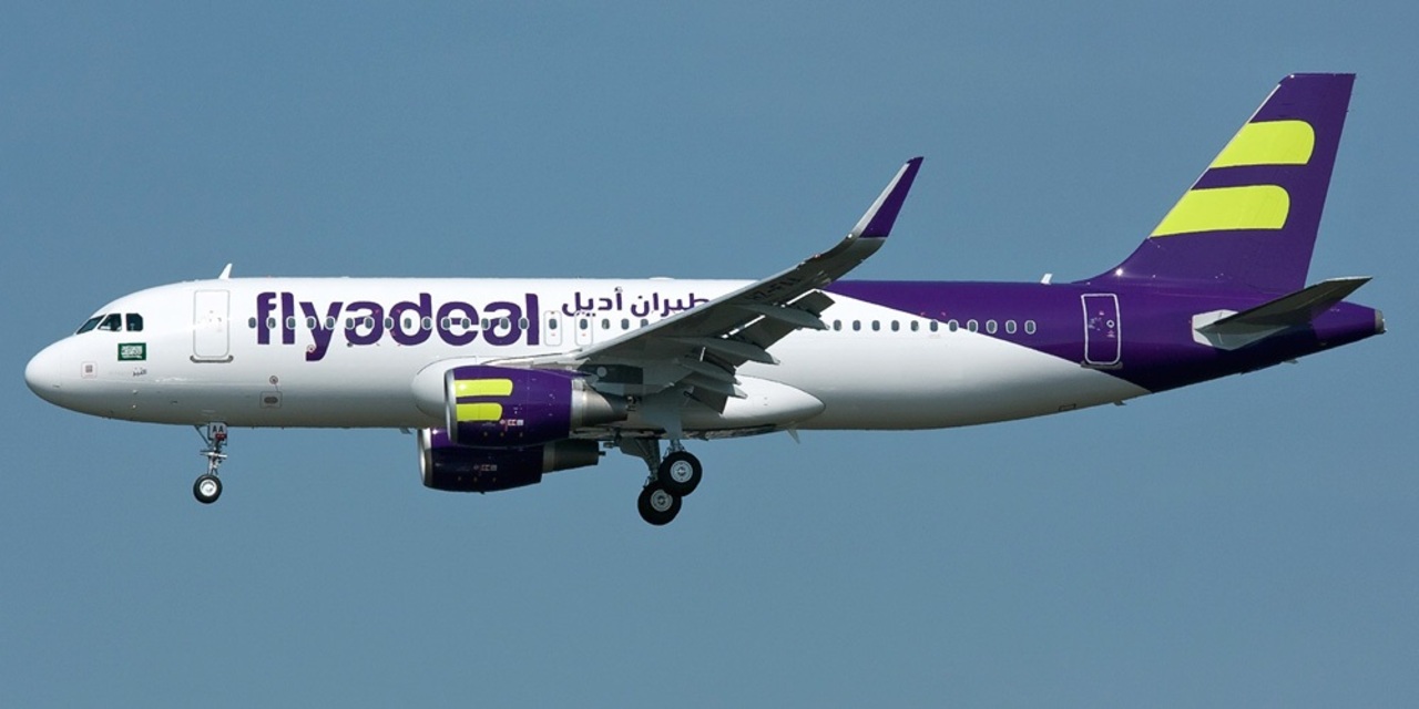 A flyadeal aircraft in flight with wheels down.