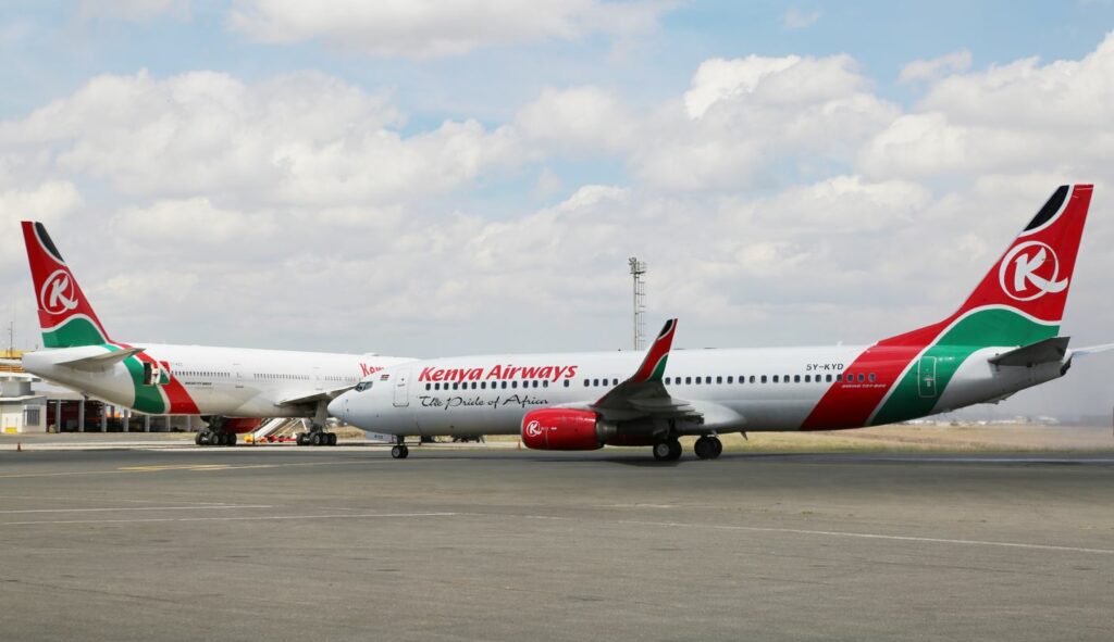 Two Kenya Airways aircraft parked on the tarmac.