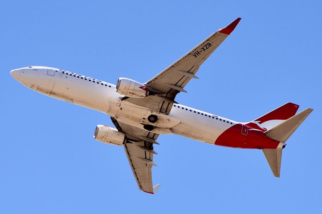 A Qantas Boeing 737 passes overhead.