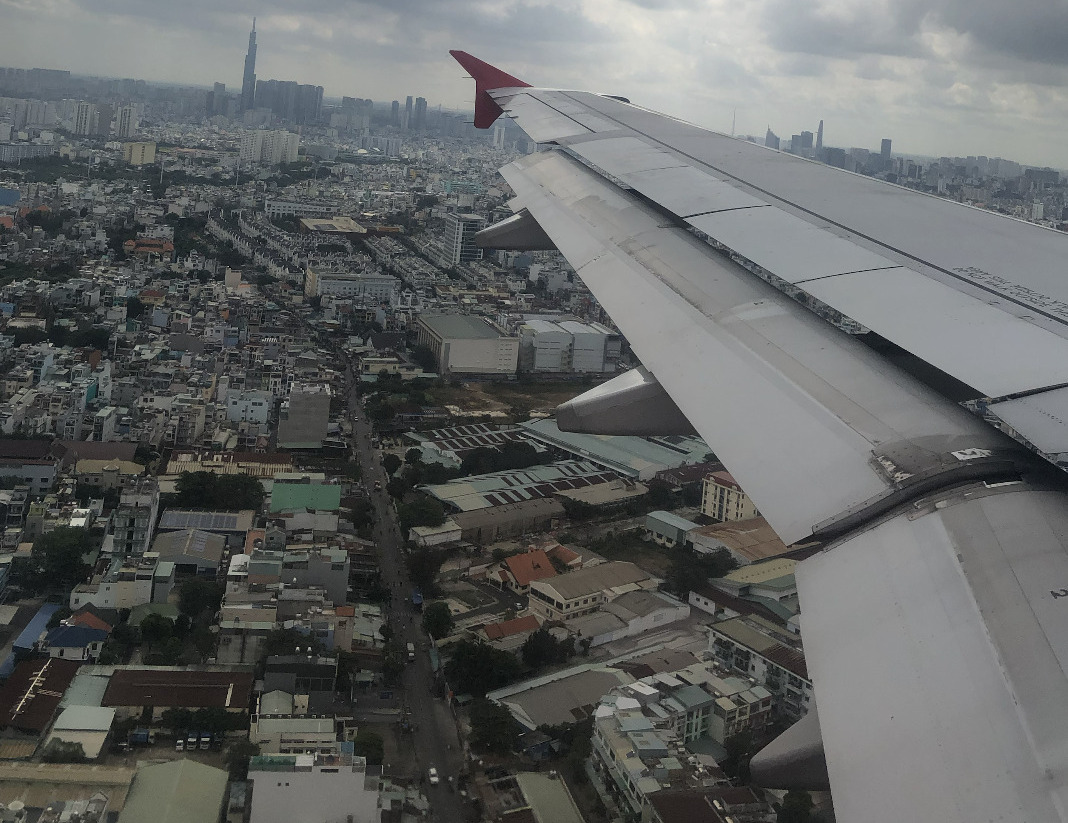 View across a VietJet Airbus wing over Ho Chi Minh City