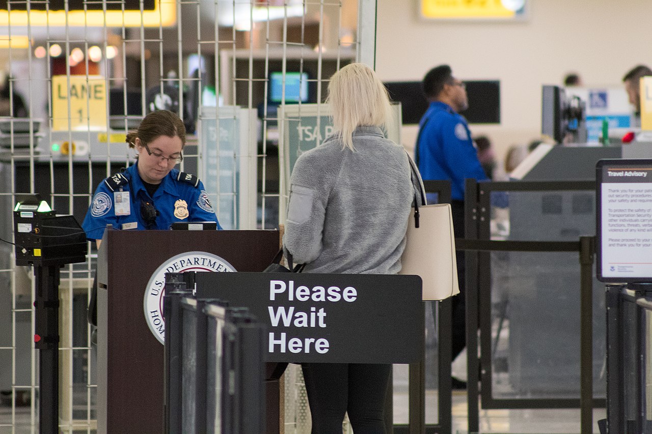 A TSA checkpoint at an international airport terminal.
