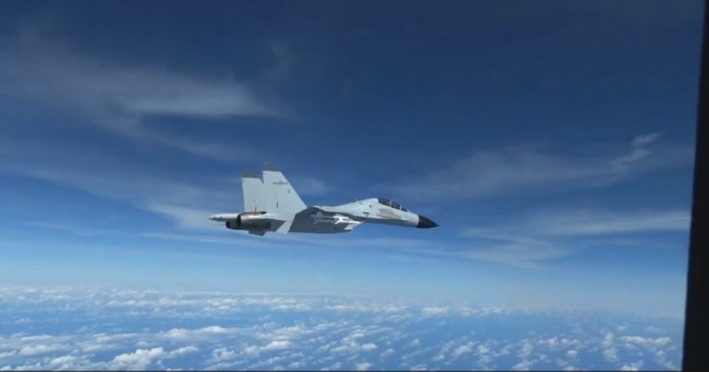 A Chinese fighter jet intercepts a US Air Force reconnaissance aircraft over the South China Sea.