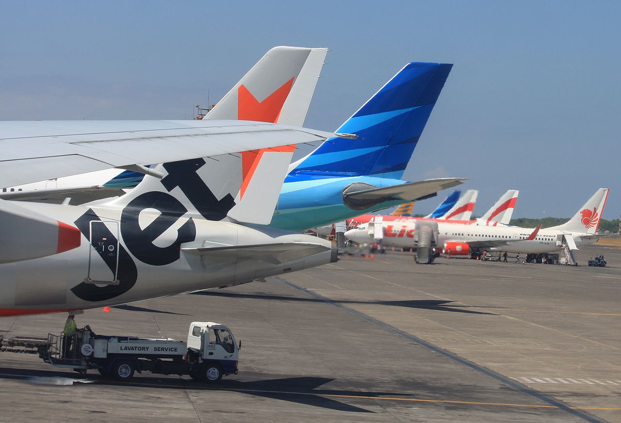 A ranger of airliners including Jetstar and Lion Air parked at Denpasar airport, Bali Indonesia.