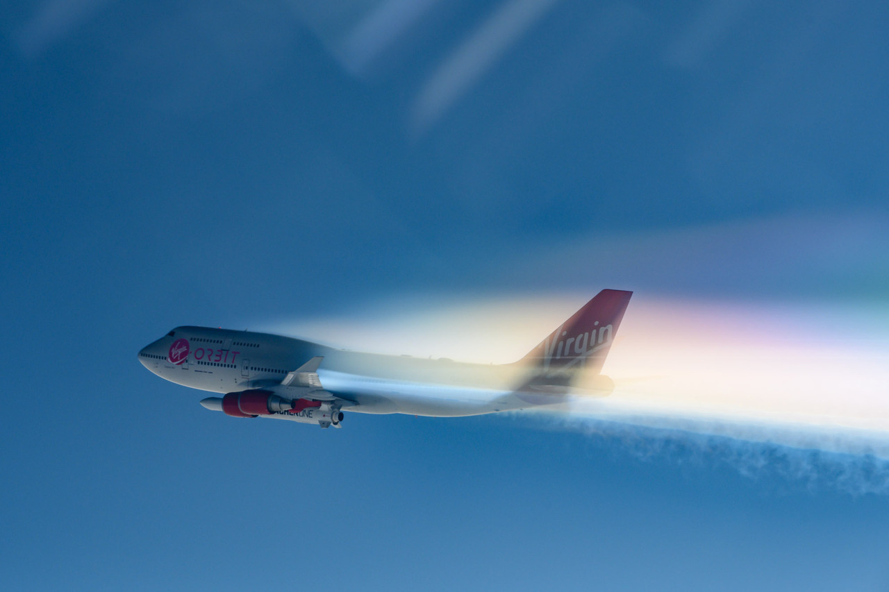 The Virgin Orbit 747 aircraft above the clouds.