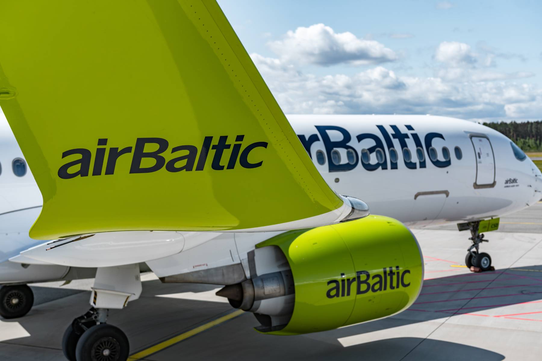 An airBaltic Airbus A220 on the taxiway.