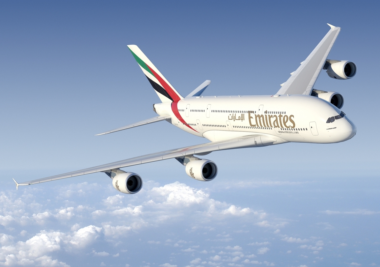 An Emirates Airbus A380 flies above cloud.