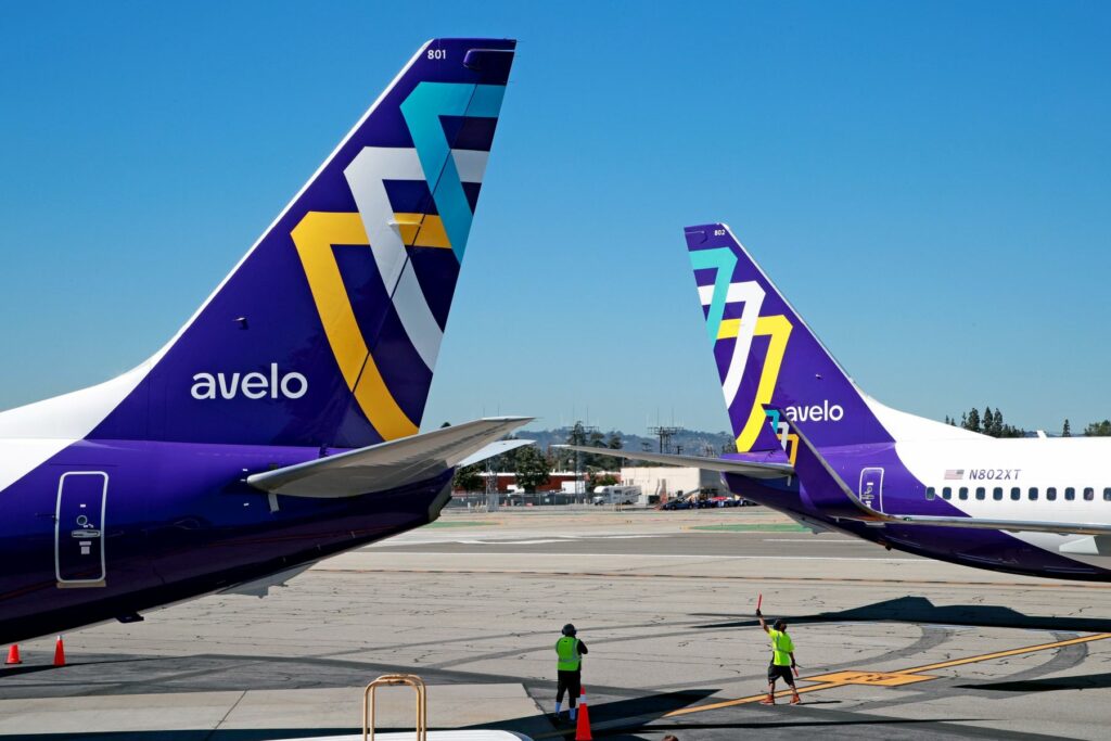 Tailplanes of Avelo Airlines aircraft on the tarmac.