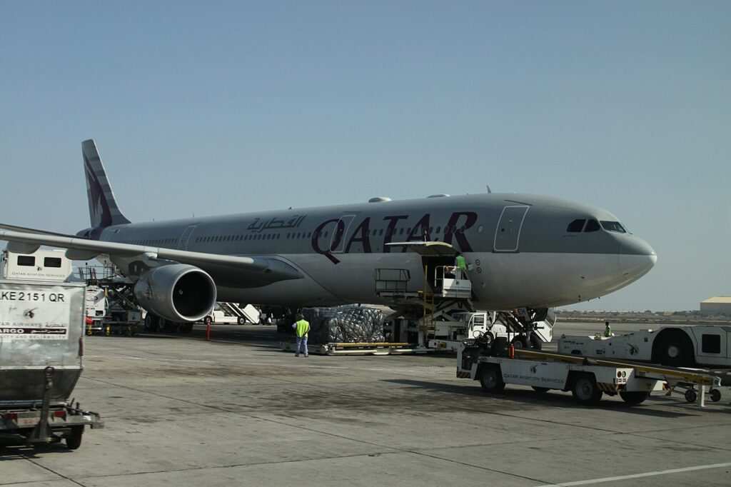 A Qatar Airways A330 being loaded with cargo.