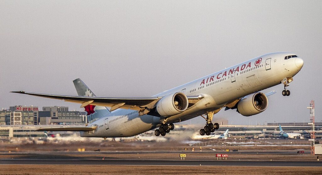 An Air Canada Boeing 777 climbs after takeoff.