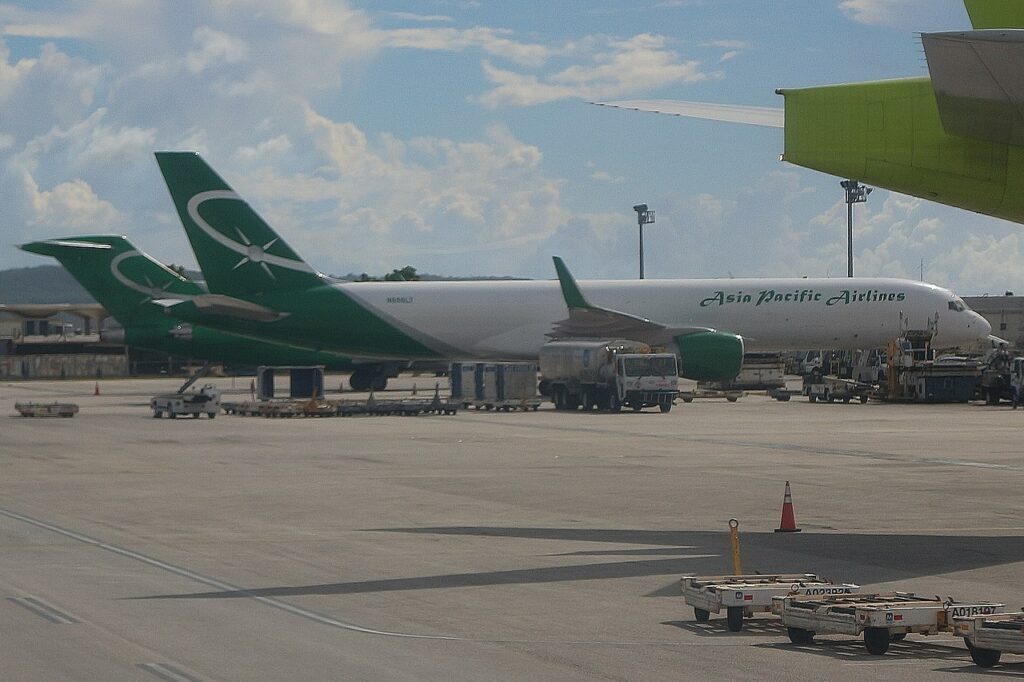 Two Asia Pacific Airlines cargo freighters parked on the tarmac.
