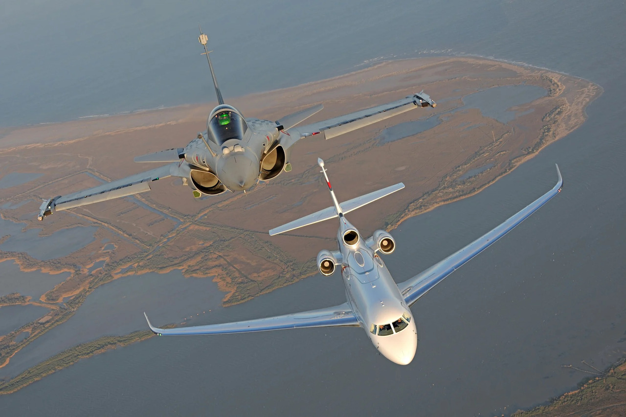 A Dassault Rafale and Dassault Falcon 8X fly together.