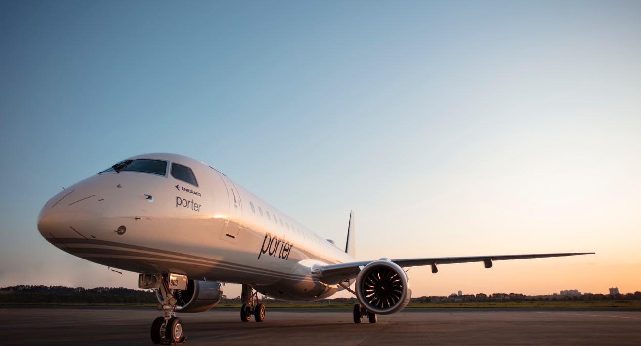 A Porter Airlines Embraer E195-E2 on the tarmac at dawn.