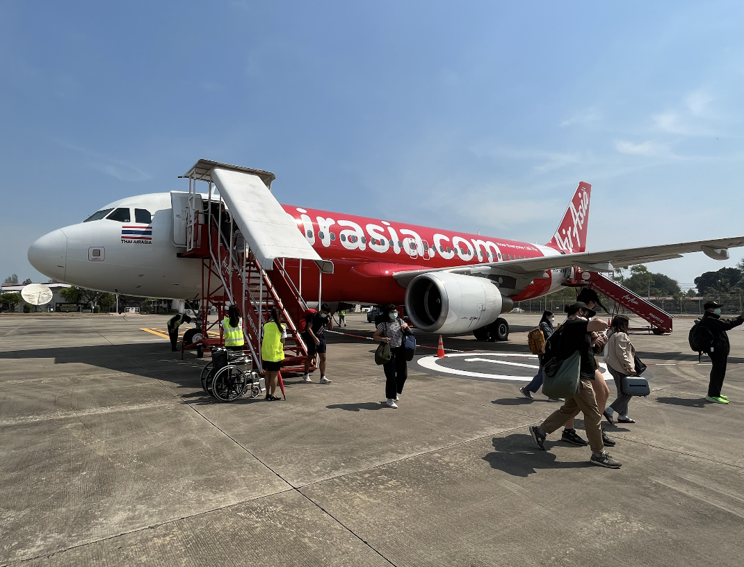 Passengers board a Thai Air Asia flight.