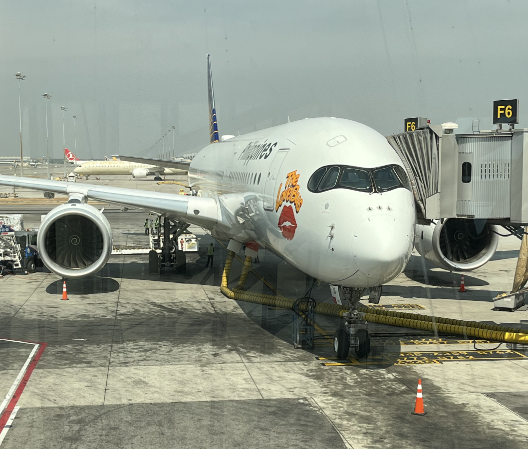 A Philippine Airlines A350 parked at the terminal.