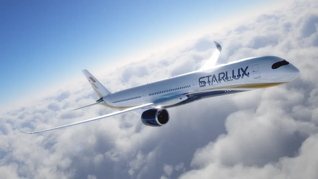 A STARLUX Airlines Airbus A350 in flight over clouds.