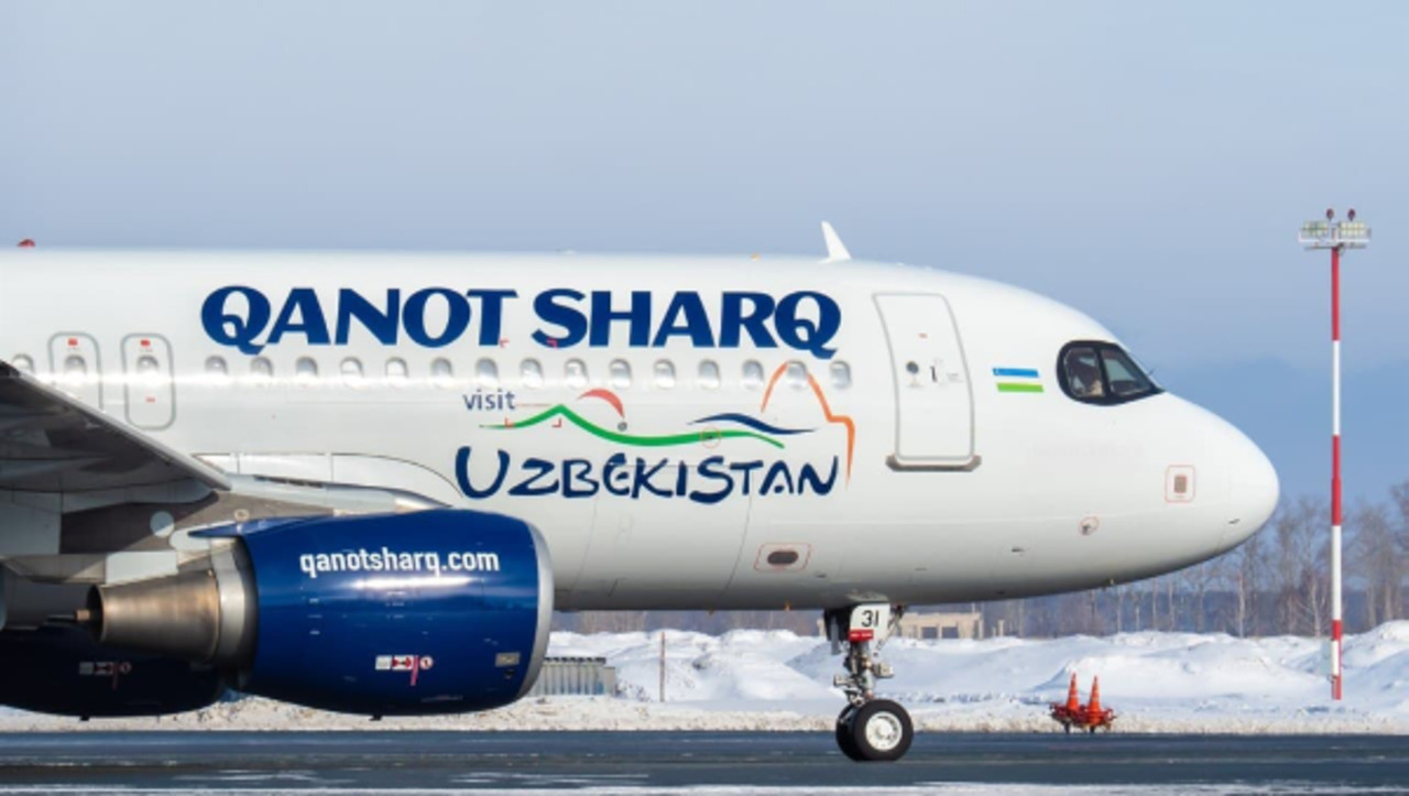 A Qanot Sharq Airlines Airbus on the taxiway.