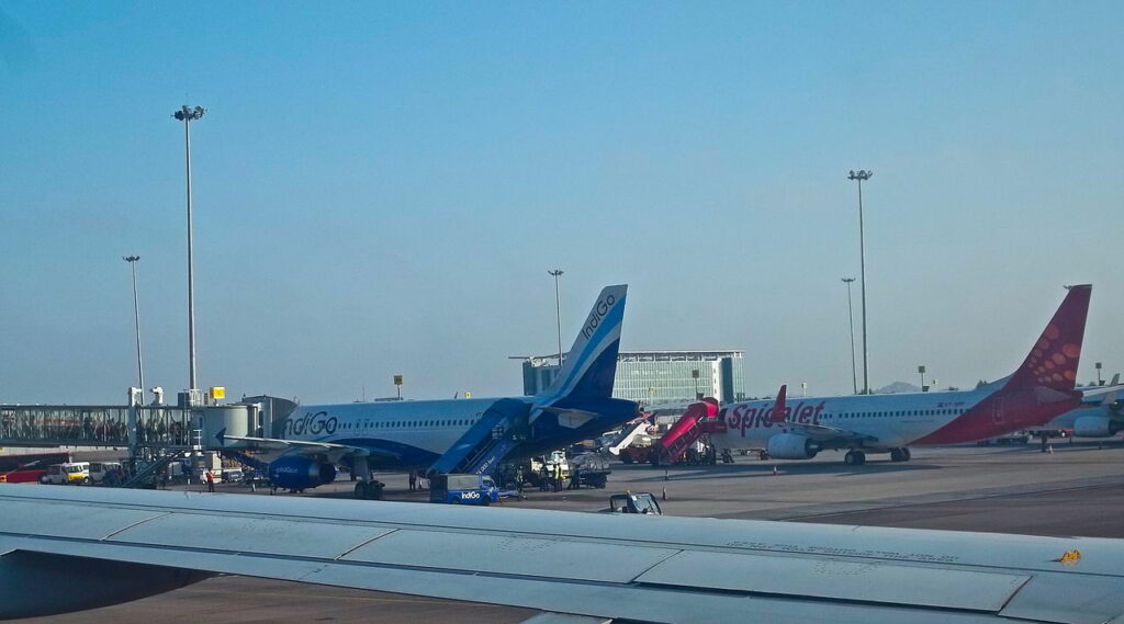 SpiceJet and IndiGo aircraft parked together at Hyderabad Airport.