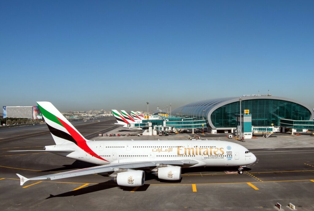 Emirates aircraft parked on the concourse.