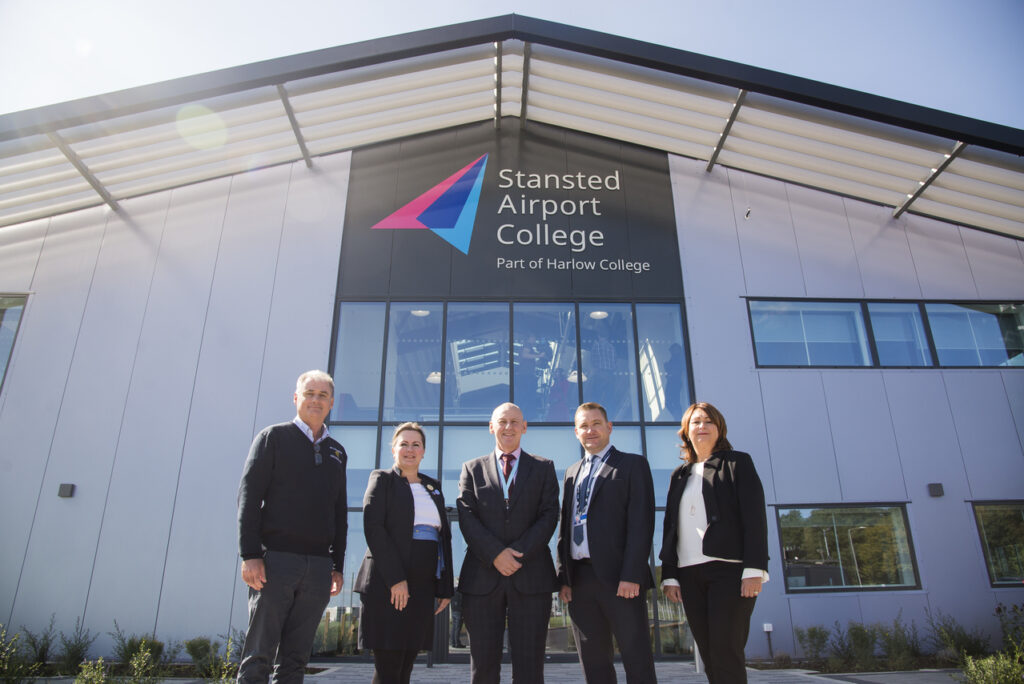 Officials pose in front of Stansted Airport College.