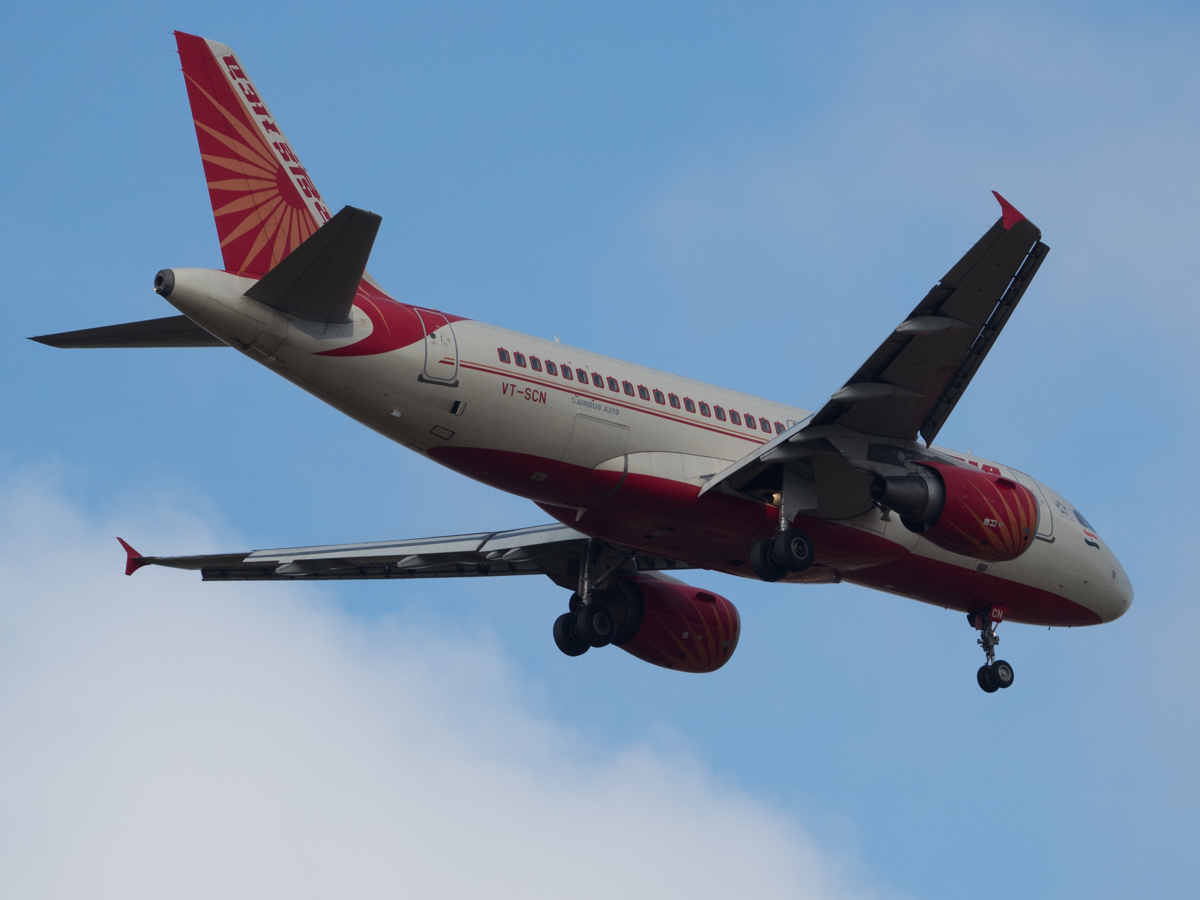 An Air India A319 passes overhead on approach to land.