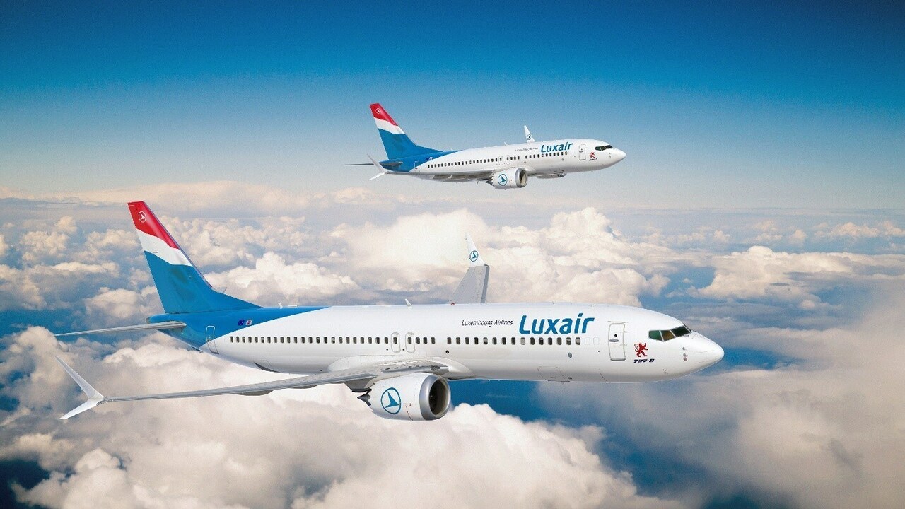 A render of two Luxair Boeing 737-8 jets in flight.