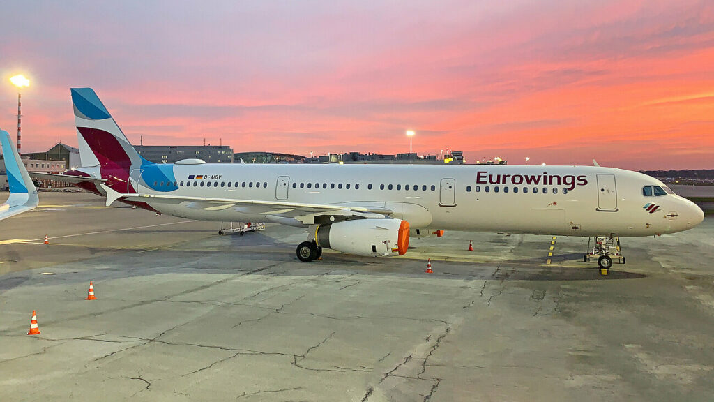 A Eurowings Airbus parked at sunset.