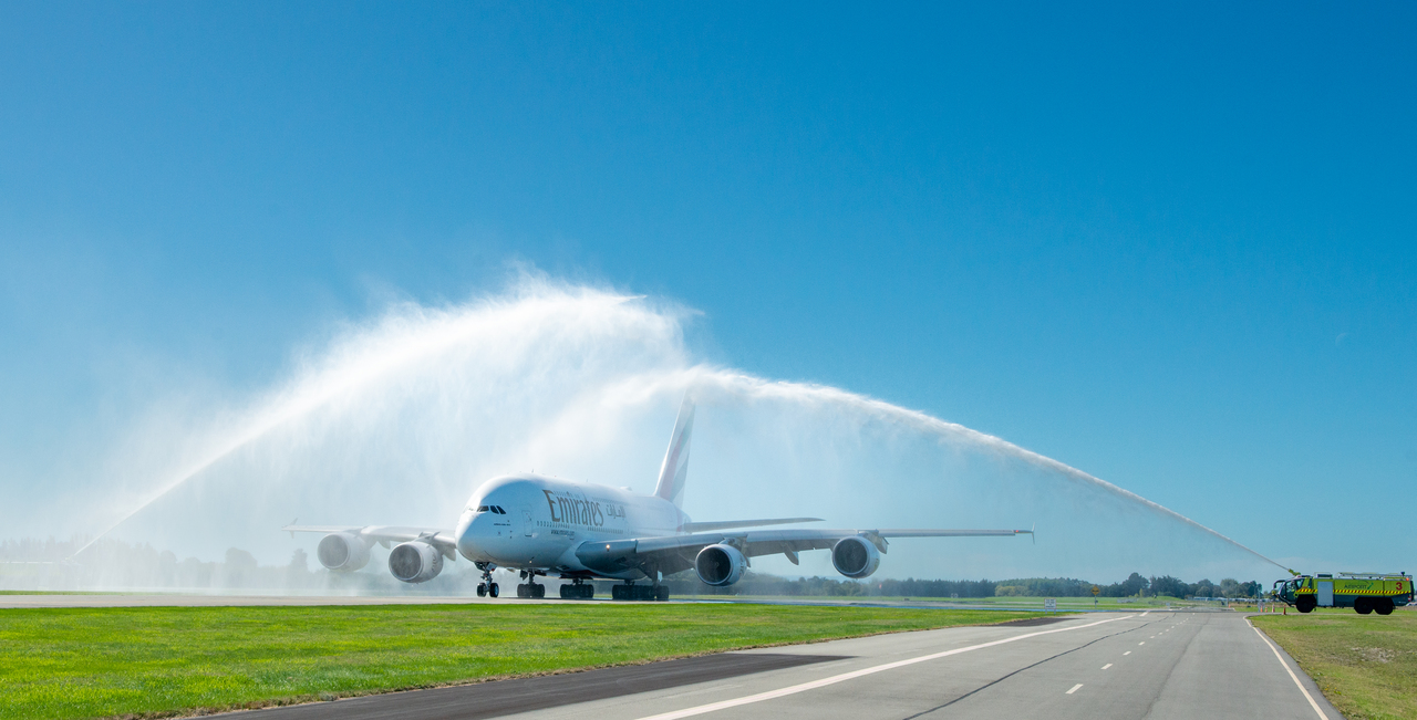 An Emirates A380 gets a water cannon salute at Christchurch Airport.